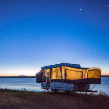 A camper parked beneath the stars at Grayrocks Reservoir in Platte County, Wyoming