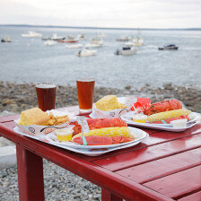 Fresh-caught lobster plated and ready to eat by the water in Camden, Maine