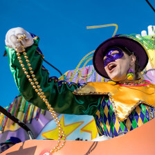 A performer throws beads from a Mardi Gras float in Louisiana