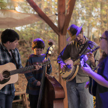 A group plays stringed instruments in West Virginia