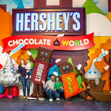 Posing with costumed characters at Hershey's Chocolate World in Hershey, Pennsylvania
