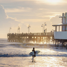 Surfer near the Daytona Beach Pier in Daytona Beach, Florida